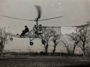 1939, September 14. DA. Stratford, Connecticut. The first flight of the VS-300, the world’s first practical helicopter, designed by Igor Sikorsky and built by the Vought-Sikorsky Aircraft Division of the United Aircraft Corporation. This was the first helicopter to incorporate a single main rotor and tail rotor design. Photo by Sikorsky Aircraft. Division of the United Aircraft Corporation (Back)