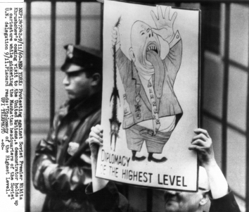 1960, September 11. CA. New York, New York. Protesting Against Soviet Premier Nikita Khrushchev's Coming visit to the United Nations, a demonstrator holds up a caricature while picketing the Manhattan headquarters of the Soviet U.N. delegation 9/11. Placard read: 